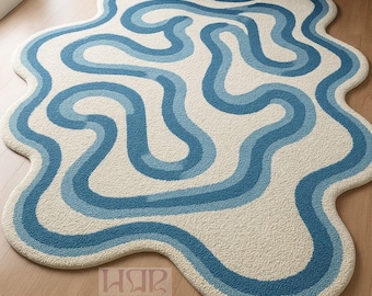 Modern abstract blauw en ivoorkleurig vloerkleed in vorm – Golvend designtapijt voor de woonkamer