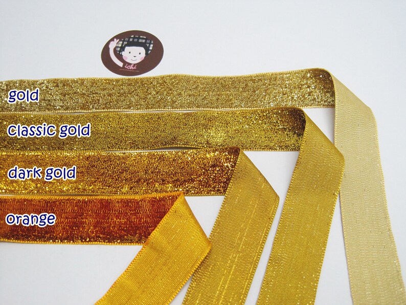 May include: Four different colors of ribbon, gold, classic gold, dark gold, and orange. The ribbon is shiny and has a metallic finish.