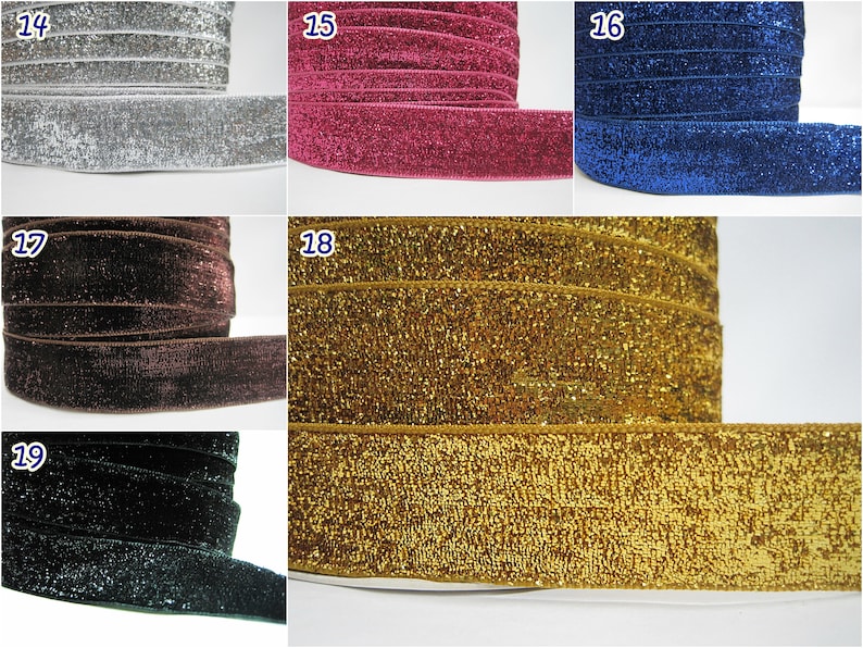 May include: Close-up of five different colors of glitter velvet ribbon. The ribbon is 1 inch wide and is available in silver, pink, blue, brown, and gold.