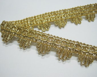 May include: Gold metallic trim with a scalloped edge. The trim has a woven chain-like pattern.