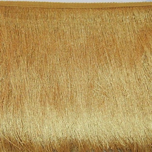 May include: Gold fringe trim with a subtle sheen. The fringe is approximately 2.5 cm in length.