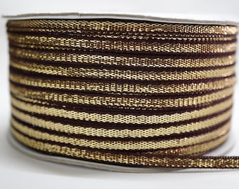 May include: A spool of decorative ribbon with alternating bands of dark brown and gold. The ribbon has a woven texture and is wound around a cardboard core. The gold bands have a metallic sheen. This ribbon is suitable for crafts and embellishments.