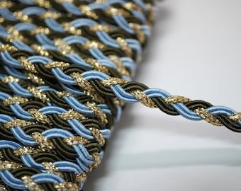 May include: A braided trim with a blue, green, and gold color scheme. The trim is made of a soft, flexible material and has a subtle sheen.