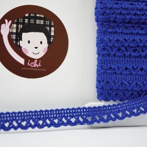 May include: Royal blue crochet trim with a delicate, intricate pattern. The trim is approximately 1 inch wide and has a scalloped edge.