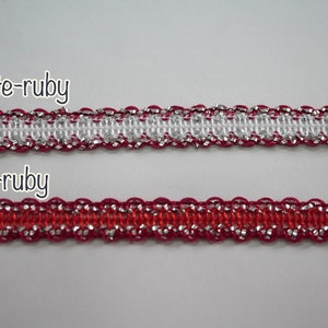 May include: Two samples of trim with silver thread. The top sample is white with red edges. The bottom sample is red with silver thread. The text "white-ruby" is above the top sample and "red-ruby" is above the bottom sample.