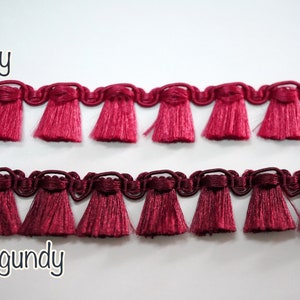 May include: Two rows of red fringe trim, one labelled "ruby" and the other "burgundy".