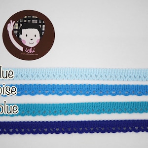 May include: Four different shades of blue lace trim, from light blue to azure. The lace trim is delicate and has a scalloped edge.