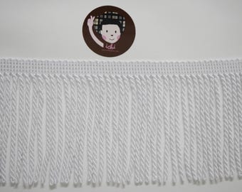 Può includere: Passamaneria con frange bianche con bordo superiore intrecciato e lunghe frange ritorte. La passamaneria è di colore bianco brillante ed è adatta a vari progetti di artigianato e cucito. Sullo sfondo un adesivo circolare con un personaggio dei cartoni animati.