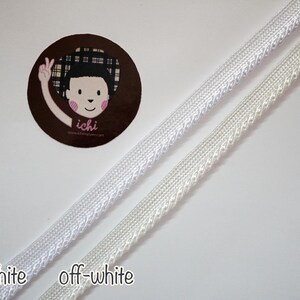May include: Two white trims with different shades of white. The trim on the left is labeled "white" and the trim on the right is labeled "off-white".