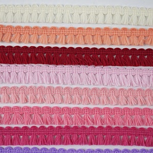 May include: Seven rows of white, peach, red, pink, light pink, hot pink, and purple fringe trim. Each row is labelled with a number from 1 to 7.