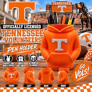 May include: An orange 3D printed pen holder shaped like a hooded sweatshirt with a white Tennessee Volunteers T logo on the front. The holder features a front pocket design and is shown from multiple angles including front, back, and side views.