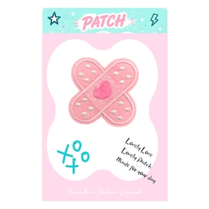 Op de afbeelding: Roze patch met twee overlappende pleisters, elk met witte stippen en een roze hart. De patch heeft het woord "PATCH" bovenaan, met de tekst "Lovely Love, Lovely Patch, Made for your day" eronder. De patch staat op een roze achtergrond.