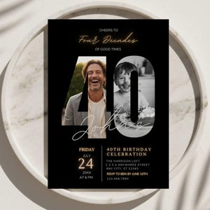 May include: Black 40th birthday invitation with a photo of a man and a child. The invitation includes the text "Cheers to Four Decades of Good Times" and event details. The invitation is on a white marble tray.