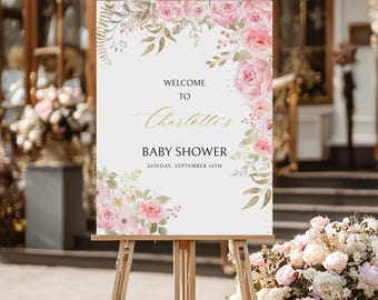 May include: A wooden easel displays a baby shower welcome sign. The sign features the text "Welcome to Charlotte's Baby Shower" in elegant script, surrounded by pink floral arrangements and gold accents. The date is noted as Sunday, September 14th.