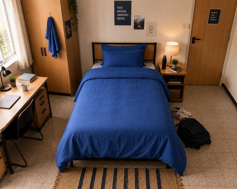 Royal blue linen duvet cover set styled on a modern bed with matching pillow covers in a cozy minimalist bedroom