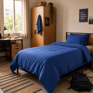 Royal blue linen duvet cover set styled on a modern bed with matching pillow covers in a cozy minimalist bedroom