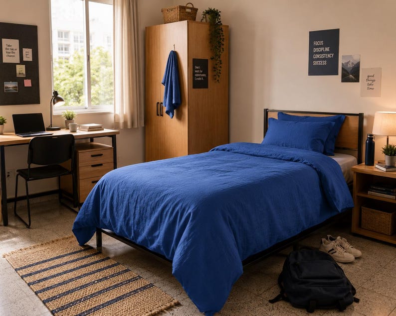 Royal blue linen duvet cover set styled on a modern bed with matching pillow covers in a cozy minimalist bedroom