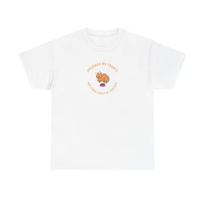 May include: White t-shirt with a circular graphic featuring an orange cat and the text "POWERED BY TREATS AND POOR IMPULSE CONTROL" in orange. The cat is sitting on a pink treat. The shirt is a casual, everyday wear item.
