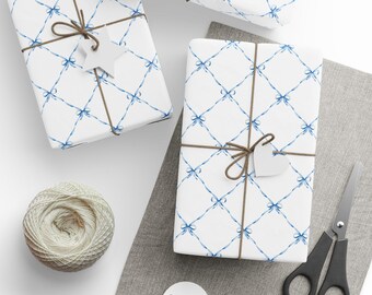 May include: Several wrapped gifts with white paper featuring a blue bow pattern. Each package is tied with brown twine and adorned with a white star or heart-shaped tag. A ball of twine, scissors, and blank tags are also present.