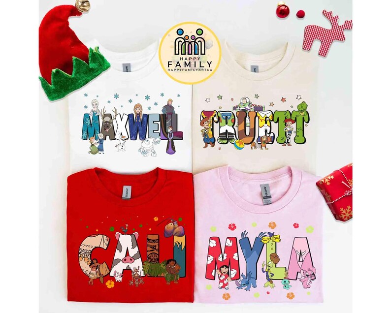 May include: Four t-shirts with personalized names and cartoon characters. The names "MAXWELL", "TRUETT", "CAILI", and "MYLA" are displayed in colourful, playful fonts. The shirts are white, beige, red, and pink. A Christmas elf hat and ornaments are in the background.