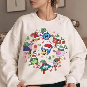 May include: A set of three ceramic mugs with a speckled, matte finish. The mugs are in shades of cream, light gray, and dark gray. Each mug has a simple, minimalist design, perfect for coffee or tea.