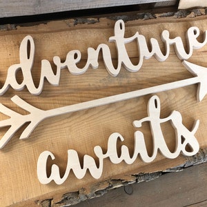 Adventure awaits signs with an arrow in the not painted finish. The signs are made of 6mm thick plywood and are suitable for wall decor.