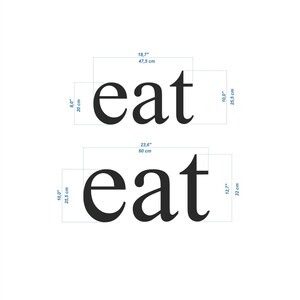 May include: Two black wooden signs with the word "eat" in white lettering. The top sign is 18.7 inches by 10 inches and the bottom sign is 23.6 inches by 12.7 inches.