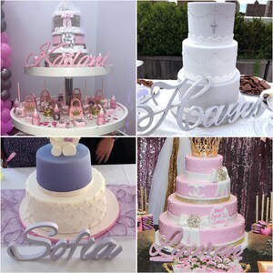 May include: Four tiered cakes decorated with pink, white, and gold frosting. Each cake has a wooden name sign in front of it: Karlani,  Sofia,  Haavyer, and La'vreese.