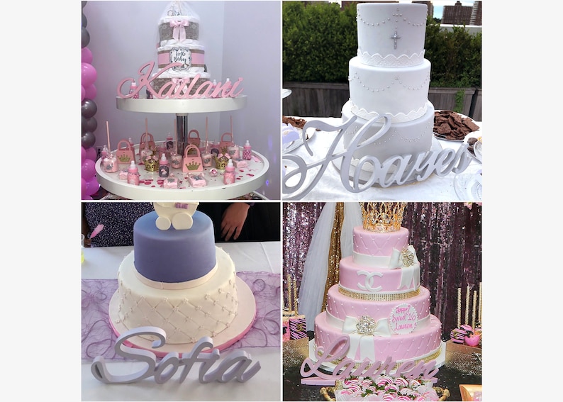 May include: Four tiered cakes decorated with pink, white, and gold frosting. Each cake has a wooden name sign in front of it: Karlani,  Sofia,  Haavyer, and La'vreese.