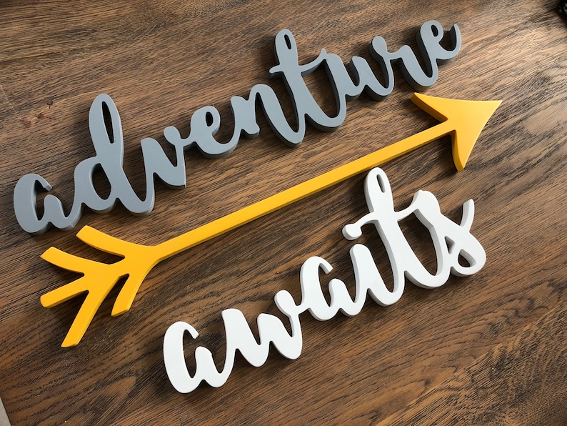 Adventure awaits signs with an arrow. The signs are made of 6mm thick plywood and are suitable for wall decor. Adventure is painted in Middle grey, awaits in white, the arrow - in Mustard yellow