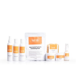 May include: A collection of skincare products from Lumis Skincare, including sprays, pads, and creams. The products feature orange and white labels, with text that reads "Kojic Acid & Turmeric Exfoliating Pads" and "Brightening". The items are arranged on a white background.