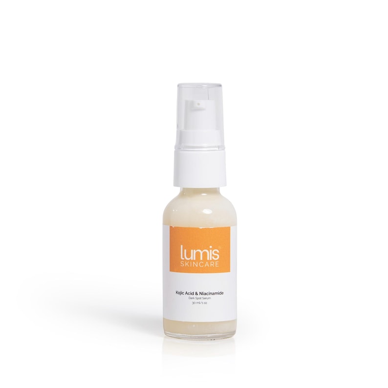 May include: A clear glass bottle with a white pump top, containing a light-colored liquid. The bottle has an orange label with the text "lumis SKINCARE" and "Kojic Acid & Niacinamide Dark Spot Serum". The bottle contains 1 fl oz of serum.