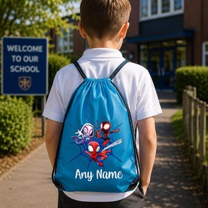 May include: A bright blue drawstring backpack featuring a graphic print of three animated spider-themed characters and a web design. The bag includes black cord straps and the white text Any Name printed in a script font at the bottom of the bag.
