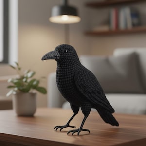 May include: A handcrafted, black crochet crow figurine with a detailed beak and legs. The bird is posed standing on a wooden surface, showcasing its textured, handmade design. The crow is a decorative item, perfect for home decor.