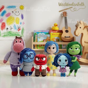 May include: A collection of handmade crochet dolls inspired by the characters from the movie "Inside Out." The dolls feature vibrant colors and detailed designs, including Joy in a yellow dress, Sadness in blue, and Anger in red. The dolls are displayed in a playful setting.