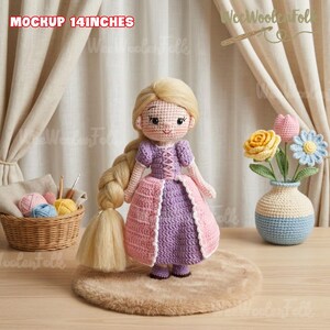 May include: A handmade crochet doll, approximately 14 inches tall, with blonde hair and a purple and pink dress. The doll has a smiling face and is displayed on a small rug. The text "MOCKUP 14 INCHES" is at the top.
