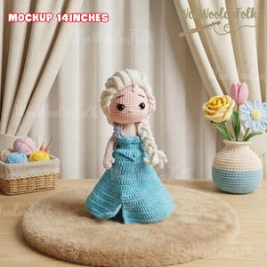 May include: A handmade crochet doll, approximately 14 inches tall, dressed in a light blue dress with a long white braid. The doll is displayed on a faux fur rug. The text "MOCKUP 14 INCHES" is visible in the image.