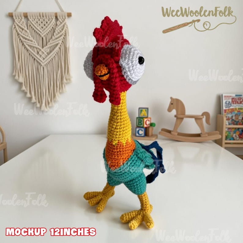 May include: A handmade crochet rooster toy, approximately 12 inches tall. The rooster features a red comb, yellow neck, and blue and green body. The eyes are white with black pupils. The toy is standing on a white surface.