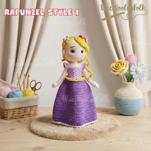 May include: A handmade crochet doll in the style of Rapunzel, wearing a purple dress with a yellow belt and bodice. The doll has blonde hair and a floral crown. The text "RAPUNZEL STYLE 1" is at the top.