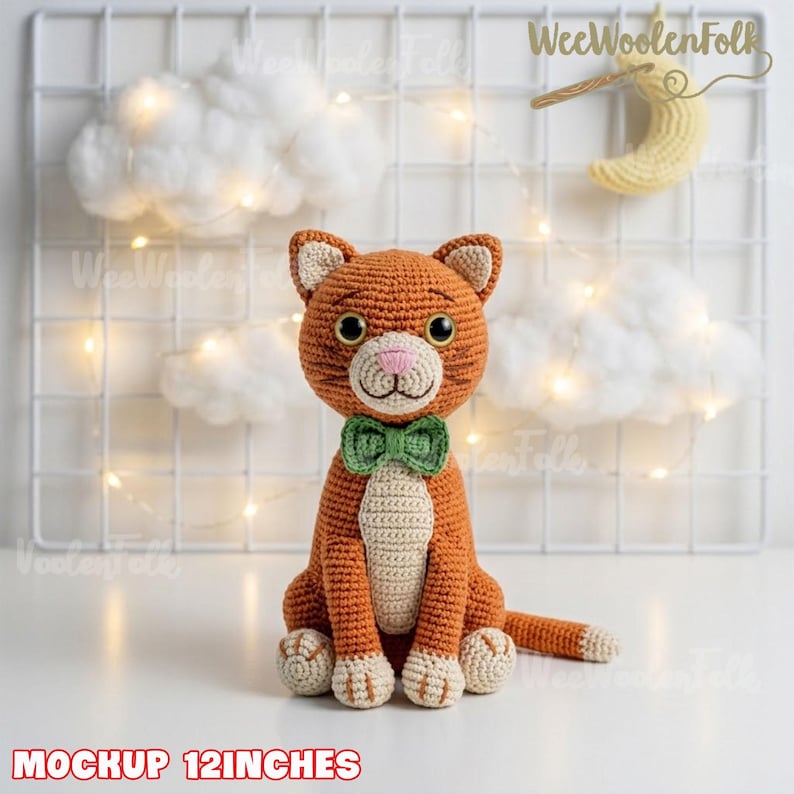 May include: A crocheted orange cat toy with a cream-colored chest, paws, and muzzle, featuring a green bow tie, black eyes, and a pink nose. The cat is 12 inches tall. The text 'WeeWoolenFolk' and 'MOCKUP 12INCHES' are visible in the image.