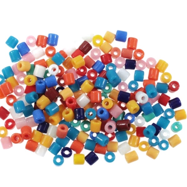 May include: A large assortment of colorful plastic beads in various shapes and sizes. The beads are a mix of red, orange, yellow, green, blue, purple, pink, and white.