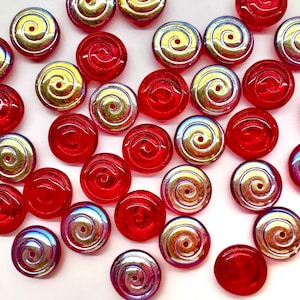 May include: An assortment of red and iridescent spiral-design beads. The red beads are solid, while the iridescent beads have a swirling pattern with gold, blue, and purple hues. These beads are suitable for jewelry making and crafts.