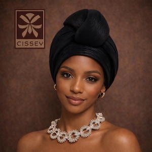 May include: A woman wearing a black turban and a beaded necklace. The turban is styled in a knot on top of the head. The necklace is made of small, round beads. The logo for "Cissey" is in the upper left corner.