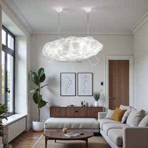 May include: A contemporary living room with a distinctive cloud-shaped pendant light. The white light fixture hangs from the ceiling. The room also features a sofa, a wooden cabinet, and framed artwork.