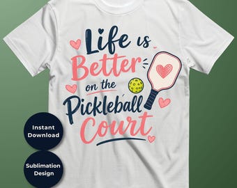 May include: A white short-sleeve t-shirt featuring the text Life is Better on the Pickleball Court in navy blue and pink script. The design includes a yellow pickleball, a pickleball paddle with a heart, and several small pink hearts.