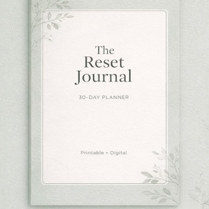 May include: A light green journal cover with the title "The Reset Journal" in a serif font. The cover also includes the text "30-DAY PLANNER" and "Printable + Digital". Decorative leaf sprigs are in the corners.