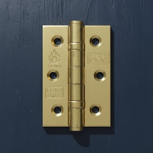 May include: A gold-coloured door hinge with six screw holes and a central barrel. The hinge features the markings "FD30/60", "CE 1121", and "i-CE". It is set against a dark blue wooden surface.