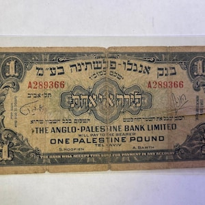 May include: An antique one Palestine pound banknote. The note features text in Hebrew and English, with the denomination "1" in each corner. The note is aged with a worn appearance.