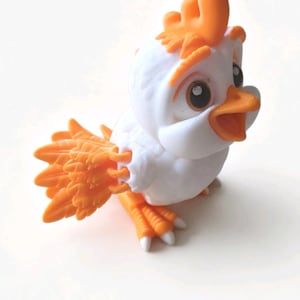 May include: A small, stylized figurine of a bird with a white body and bright orange accents on its head crest, beak, wings, and feet. The bird has large, dark eyes and an open beak, with textured feather details on the wings and tail.