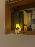 Glowing reading ghost as a night light – 3D-printed LED decoration for bookshelves & windowsills – warm white mood light product logo